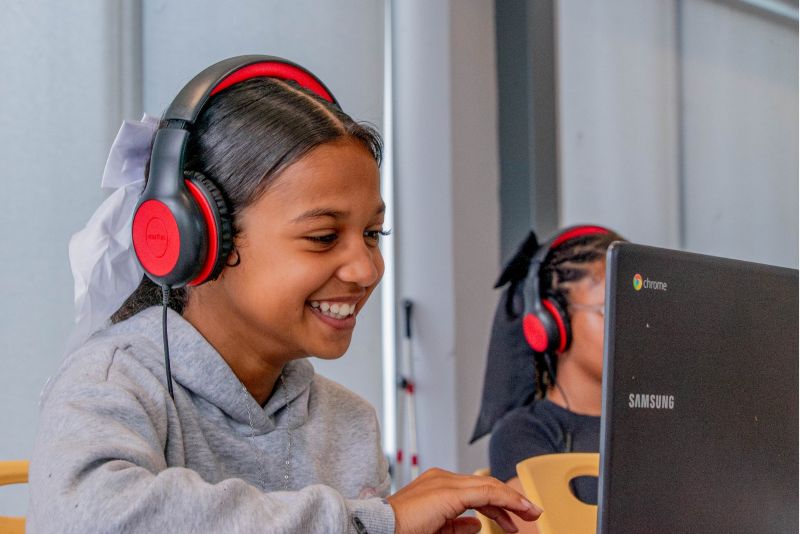 child studying on laptop